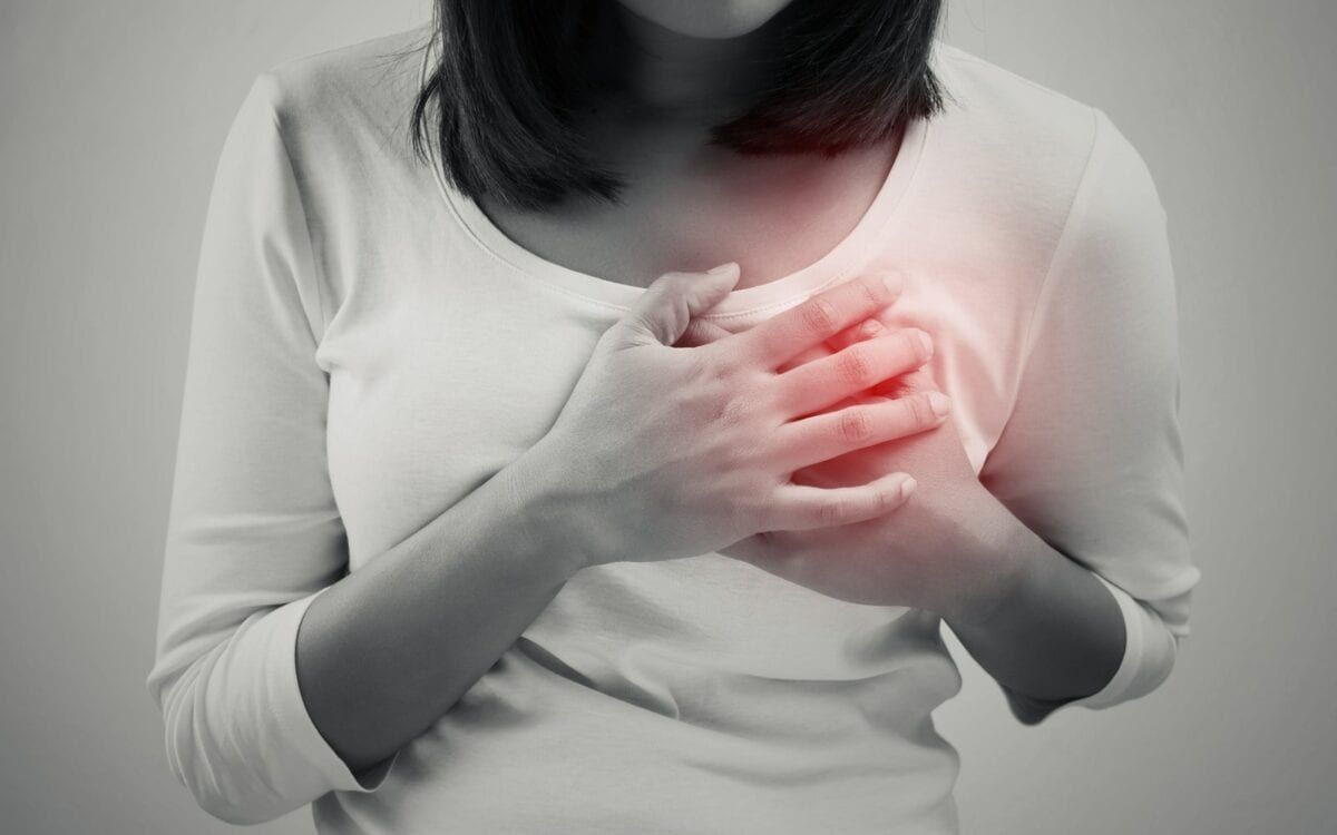 Woman clutching her heart from pain