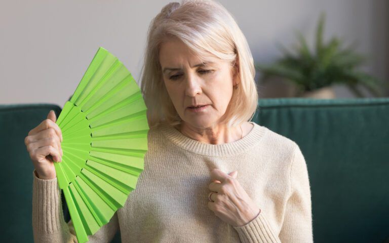 Woman experiencing hot flashes