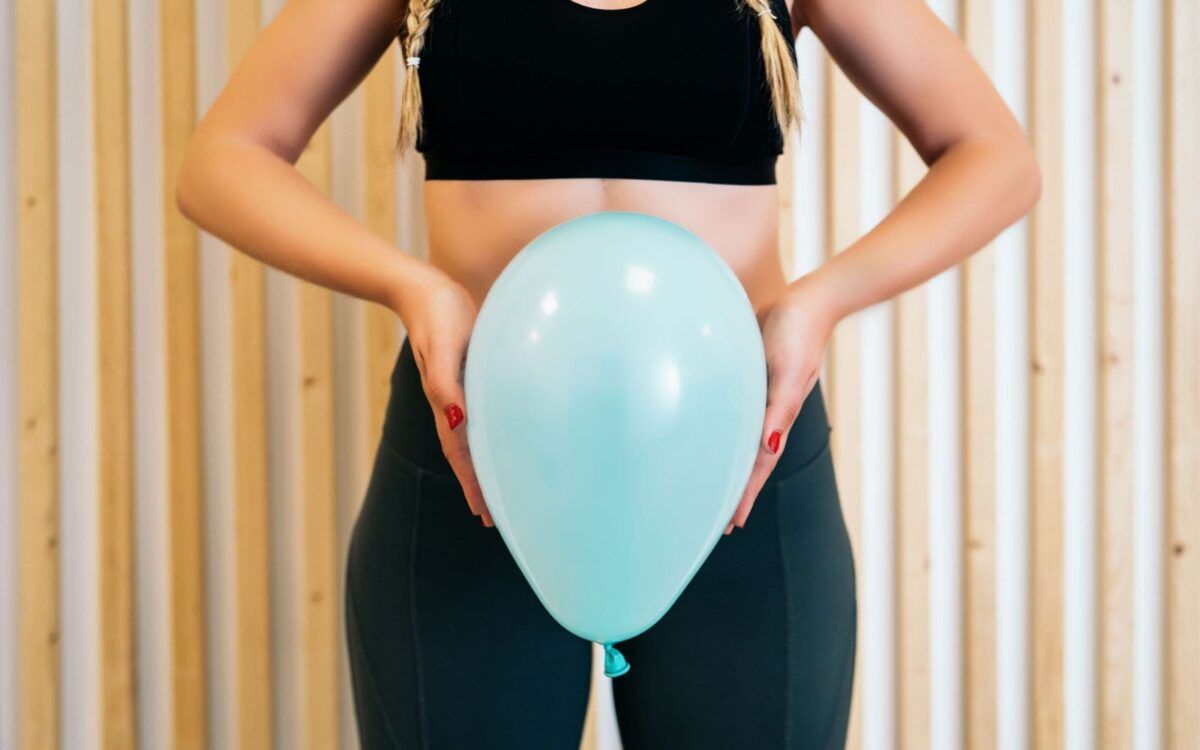 Woman holding Balloon showing Pelvic Floor