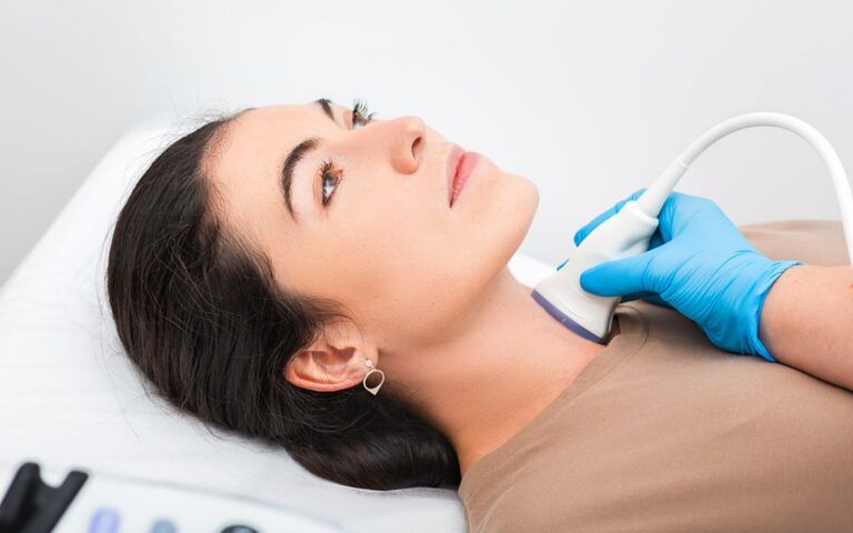 Women getting a thyroid scan